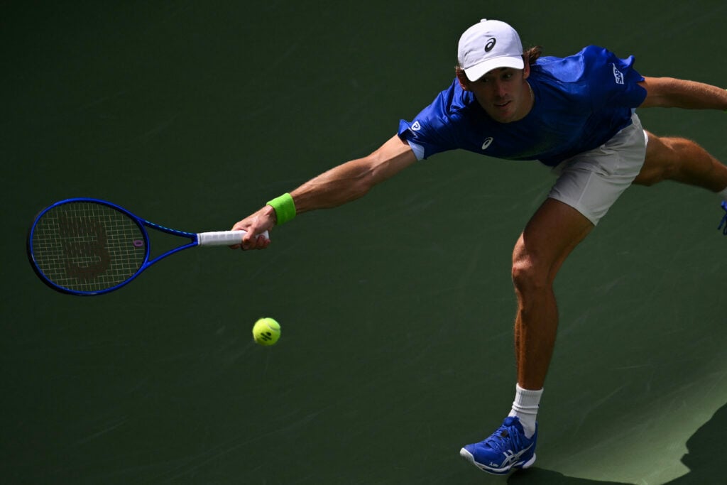 Alex De Minaur stretches for a forehand