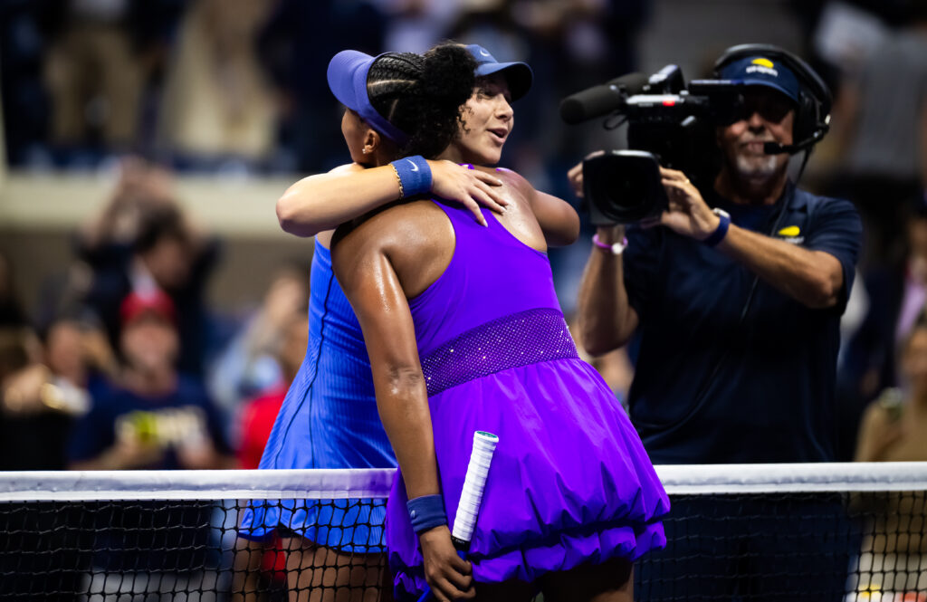 Naomi Osaka and Amanda Anisimova hug at the net