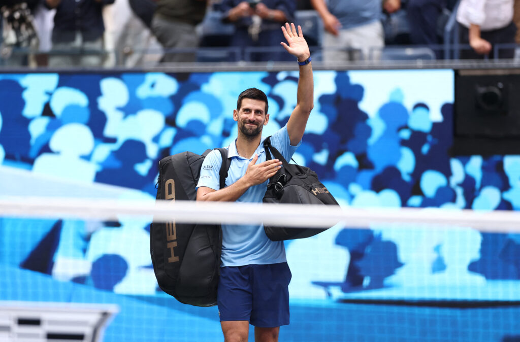 Novak Djokovic waves as he leaves the court