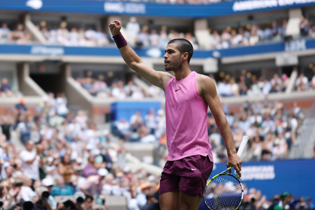 Carlos Alcaraz lifts his fist in celebration