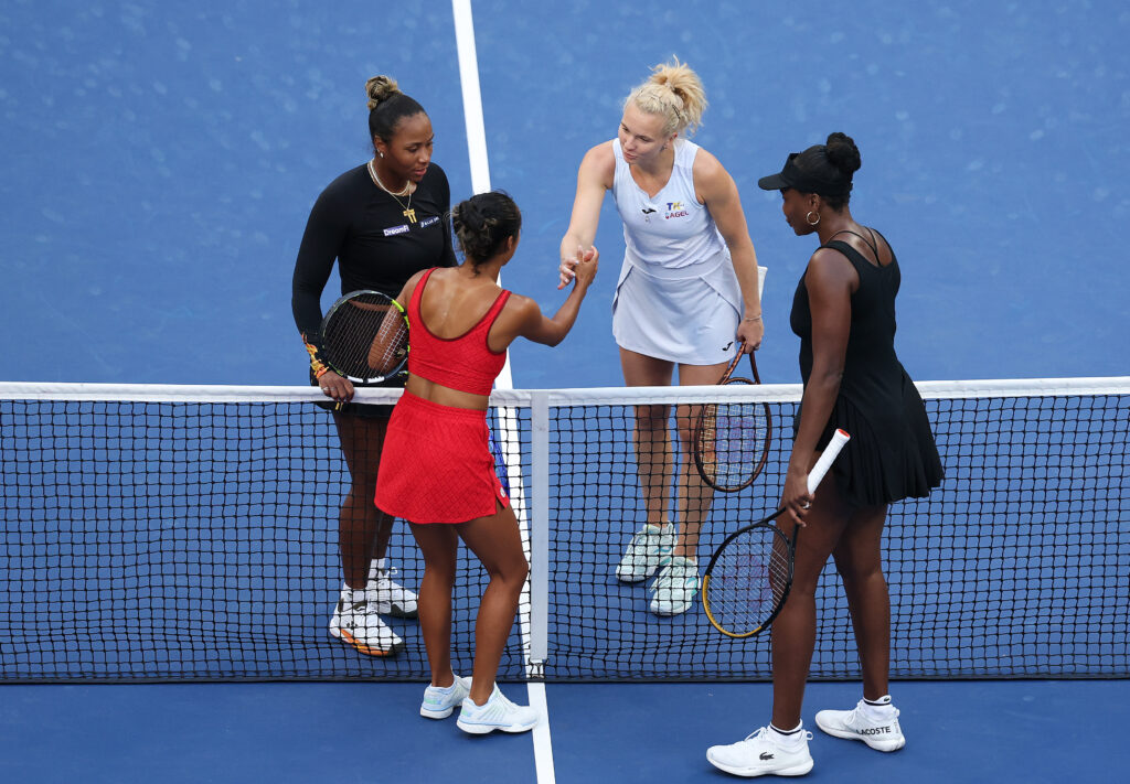 Katerina Siniakova of Czechia and Taylor Townsend of the United States shake hands after defeating Venus Williams of the United States and Leylah Fernandez of Canada at the net