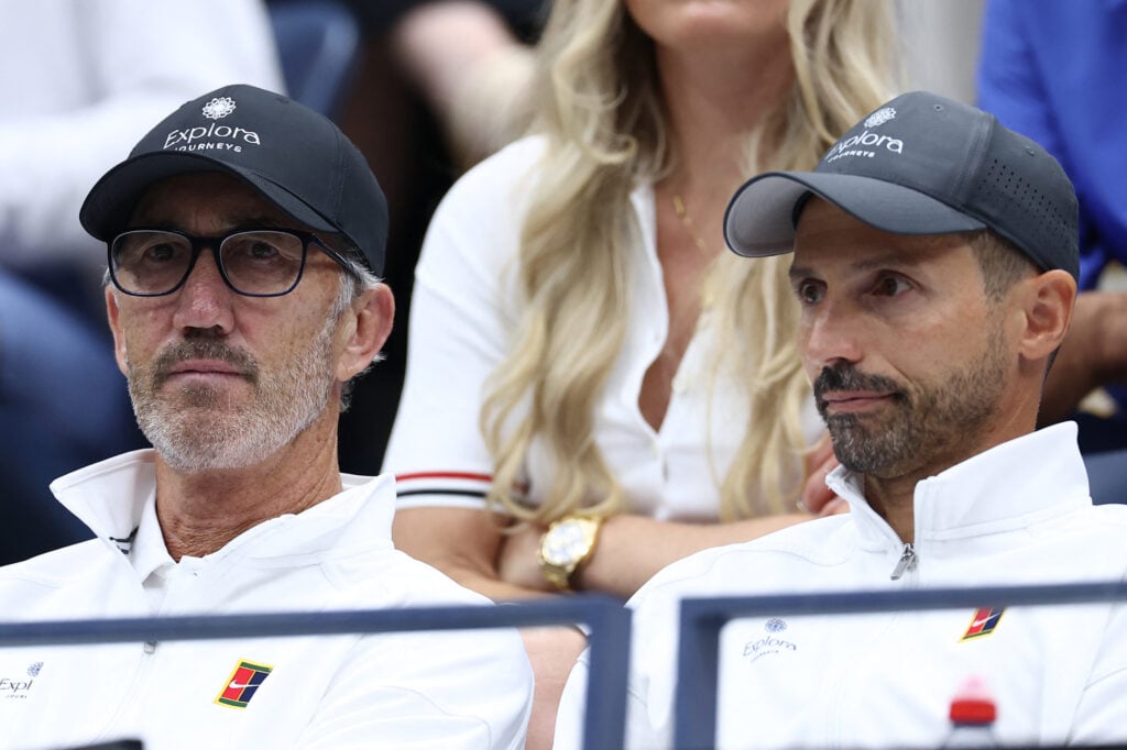 Italy's Jannik Sinner's coaches Simone Vagnozzi (R) Australian former tennis player Darren Cahill, attend the men's singles final tennis match between Italy's Jannik Sinner and Spain's Carlos Alcaraz on day fifteen of the US Open tennis tournament at the USTA Billie Jean King National Tennis Center in New York City, on September 7, 2025.