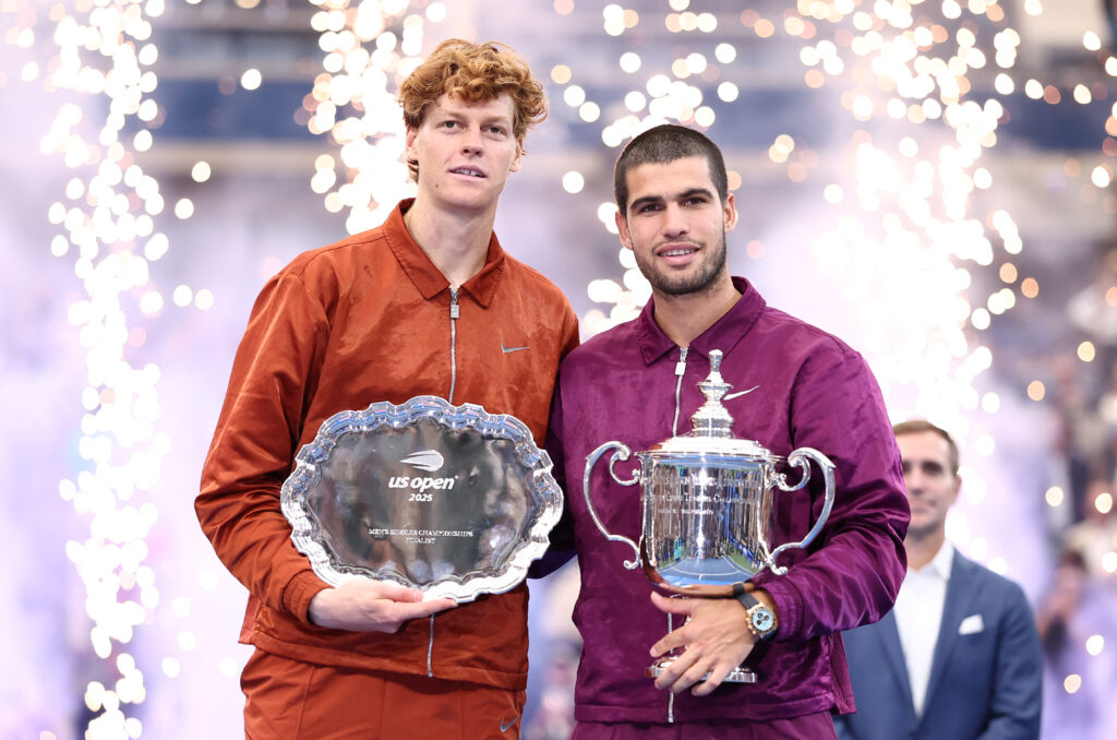 Spain's Carlos Alcaraz and Italy's Jannik Sinner pose with their trophies after Alcaraz won the men's singles final tennis match on day fifteen of the US Open tennis tournament at the USTA Billie Jean King National Tennis Center in New York City on September 7, 2025