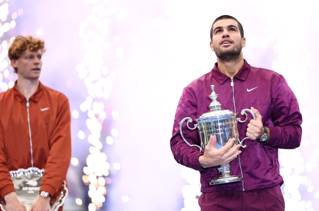 Spain's Carlos Alcaraz poses with his trophy after winning the men's singles final tennis match against Italy's Jannik Sinner (L) on day fifteen of the US Open tennis tournament at the USTA Billie Jean King National Tennis Center in New York City on September 7, 2025.