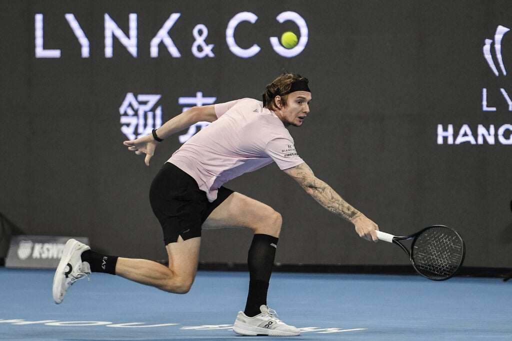 Kazakhstan's Alexander Bublik hits a return to China's Wu Yibing during their men's singles semi-final match at the Hangzhou Open tennis tournament in Hangzhou, in China's eastern Zhejiang province on September 22, 2025.