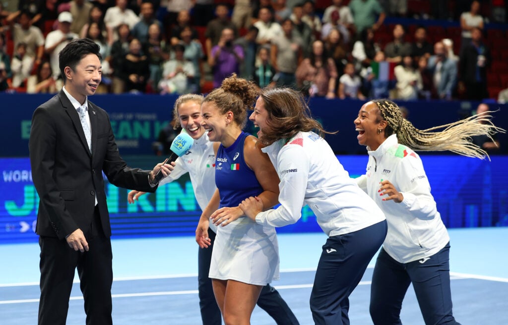 Jasmine Paolini of Italy is interviewed whilst her teammates Lucia Bronzetti, Elisabetta Cocciaretto and Tyra Caterina Grant celebrate with her after winning match 2 and the Billie Jean King Cup by Gainbridge Finals 2025, Final match between Italy and USA at Shenzhen Bay Sports Centre Arena on September 21, 2025 in Shenzhen, China.