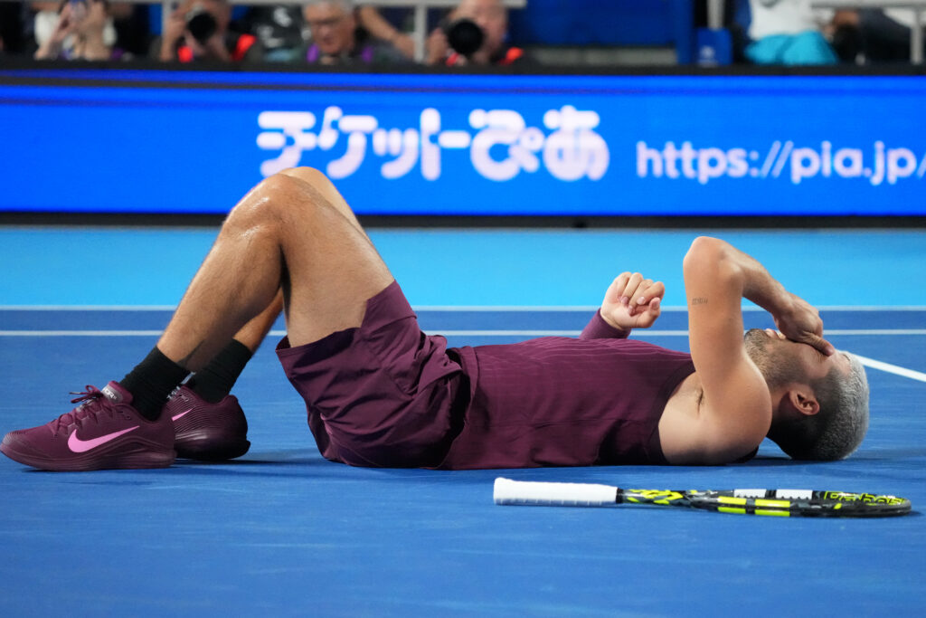 Carlos Alcaraz of Spain falls against Sebastian Baez of Argentina during the Singles Round of 32 on day two of Kinoshita Group Japan Open at Ariake Colosseum on September 25, 2025 in Tokyo, Japan.