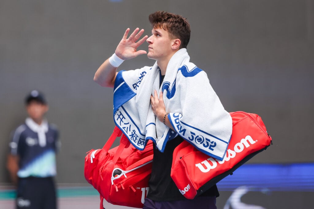 Jakub Mensik of the Czech Republic waves after he retired from the Men's Singles Quarterfinal match against Alex De Minaur of Australia on day 8 of the 2025 China Open at the National Tennis Center on September 29, 2025 in Beijing, China.