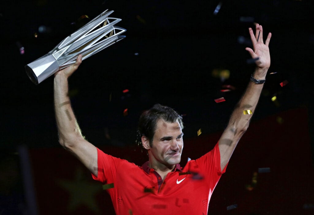 Roger Federer of Switzerland celebrates with the trophy after winning the final against Gilles Simon of France during the day 8 of the Shanghai Rolex Masters at the Qi Zhong Tennis Center on October 12, 2014 in Shanghai, China.