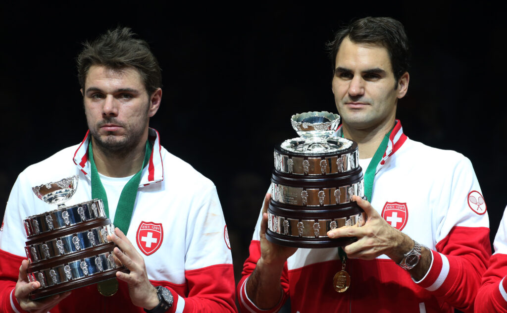 Stanislas Wawrinka and Roger Federer hold Davis Cup trophies