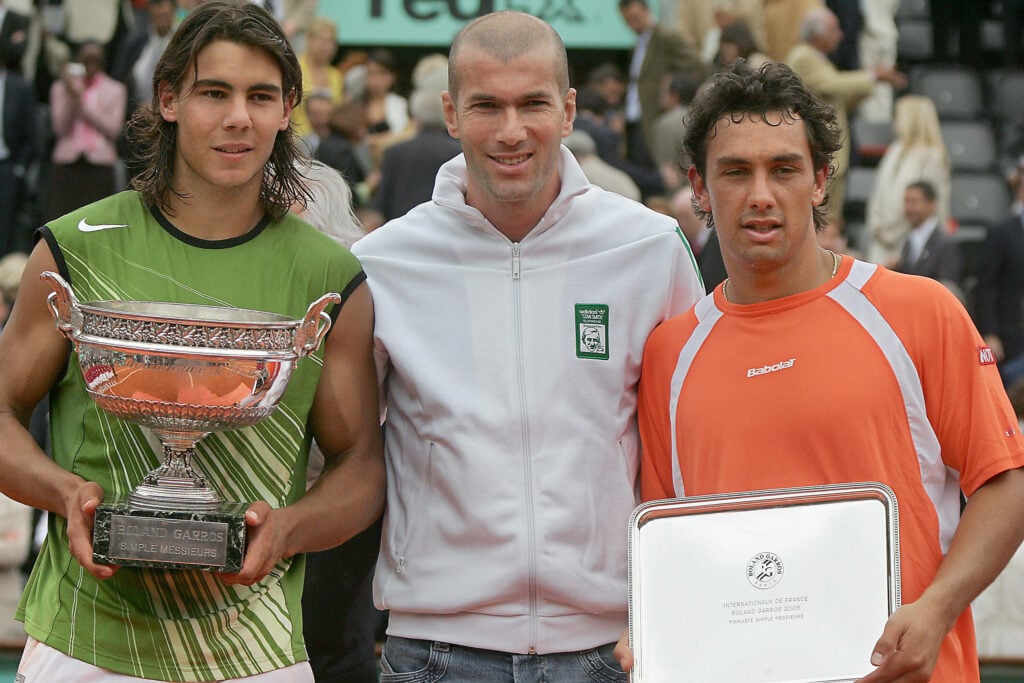 Spanish Rafael Nadal (L) and Argentinian Mariano Puerta (R) hold their trophies next to French football player Zinedine Zidane (C) after their men's final match of the tennis French Open at Roland Garros, 05 June 2005 in Paris. Nadal won 6-7(6) 6-3 6-1 7-5.