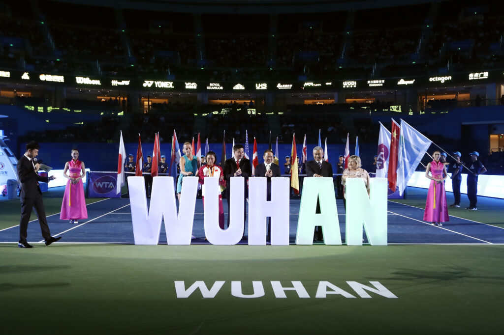 Guests press the button to lit up the logo of Wuhan at the opening ceremony of the 2016 Wuhan Open at Optics Valley International Tennis Center on September 25, 2016 in Wuhan, China.