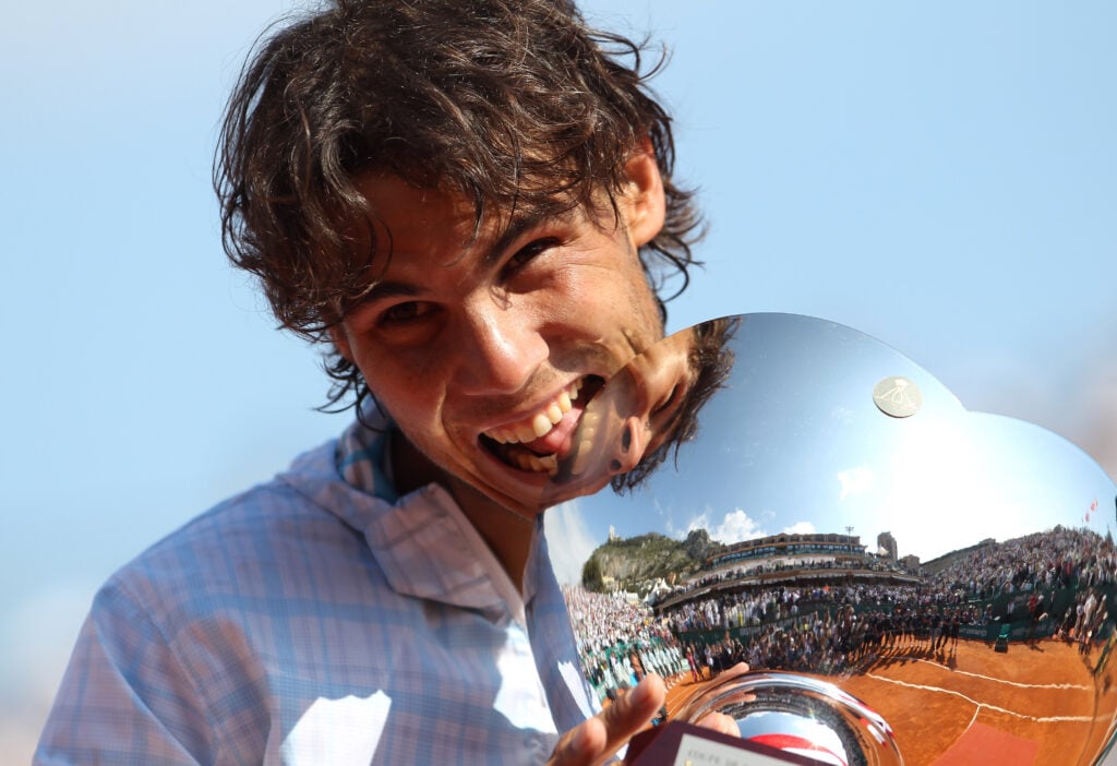 Rafael Nadal of Spain bites the trophy after defeating Fernando Verdasco of Spain in the final, during day Seven of the ATP Masters Series at the Monte Carlo Country Club on April 18, 2010 in Monte Carlo, Monaco.