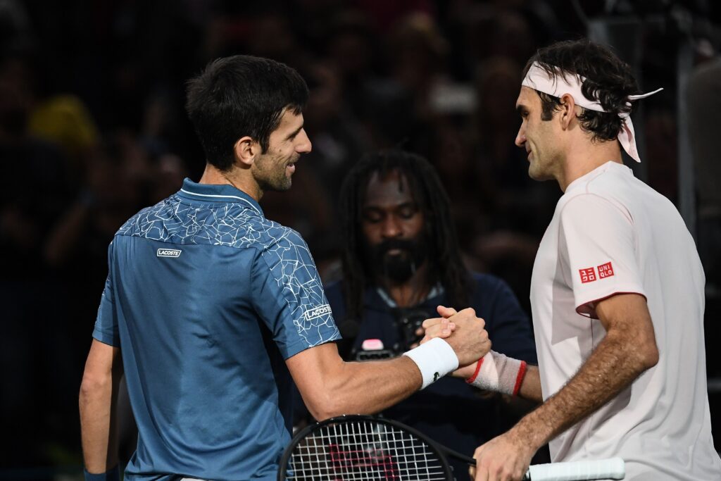 Serbia's Novak Djokovic (L) and Switzerland's Roger Federer shake hands at the end of their men's singles semi-final tennis match on day six of the ATP World Tour Masters 1000 - Rolex Paris Masters - indoor tennis tournament at The AccorHotels Arena in Paris, on November 3, 2018.