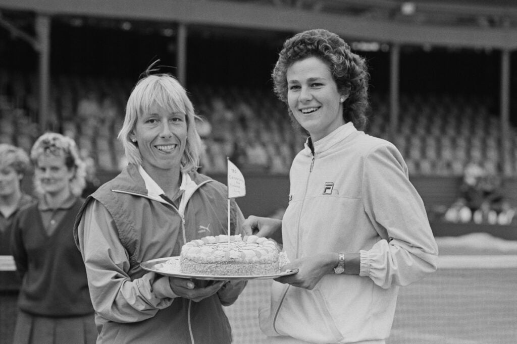 US doubles champions Martina Navratilova (left) and Pam Shriver pose with a cake to celebrate their 100th doubles win at the Pilkington Glass Tennis Championships at Devonshire Park in Eastbourne, UK, 18th June 1985.