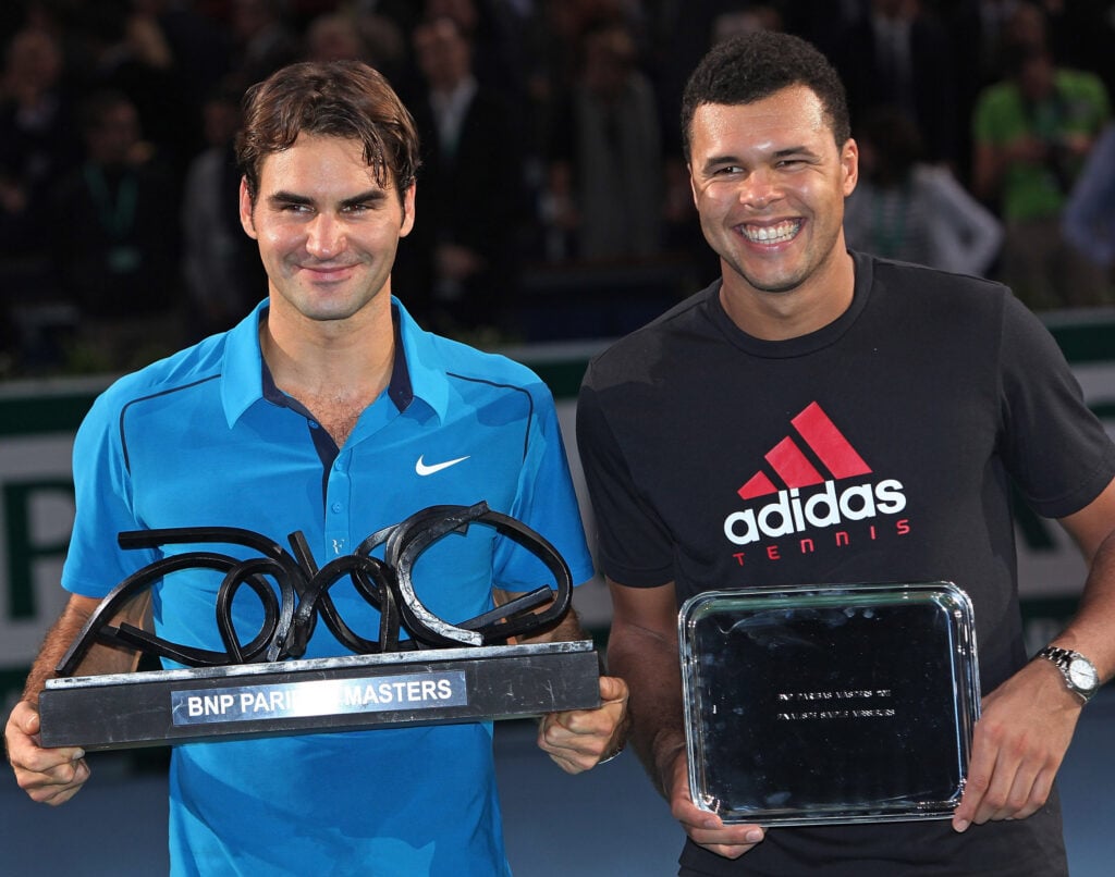 Winner Roger Federer of Switzerland (L) and runner-up Jo-Wilfried Tsonga of France hold their respective trophies after their final match in the BNP Paribas Masters at Palais Omnisports de Bercy on November 13, 2011 in Paris, France. Federer defeated Tsonga 6-1 7-6 (3) to win his first Paris Masters title.