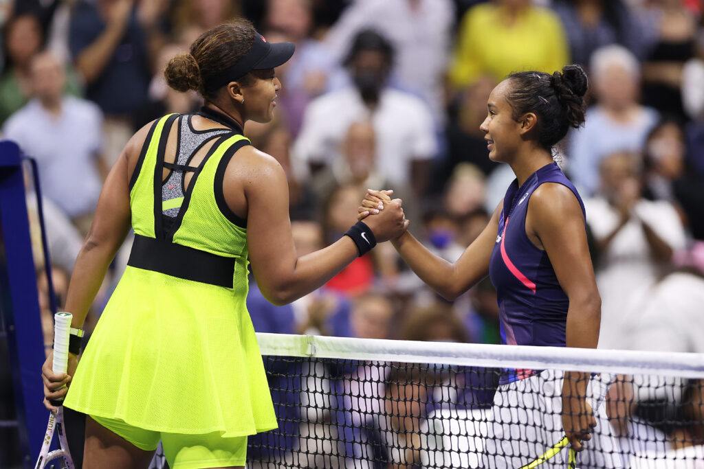 Leylah Fernandez (R) of Canada meets at the net after defeating Naomi Osaka (L) of Japan during her Women's Singles third round match on Day Five of the US Open at USTA Billie Jean King National Tennis Center on September 03, 2021 in New York City.