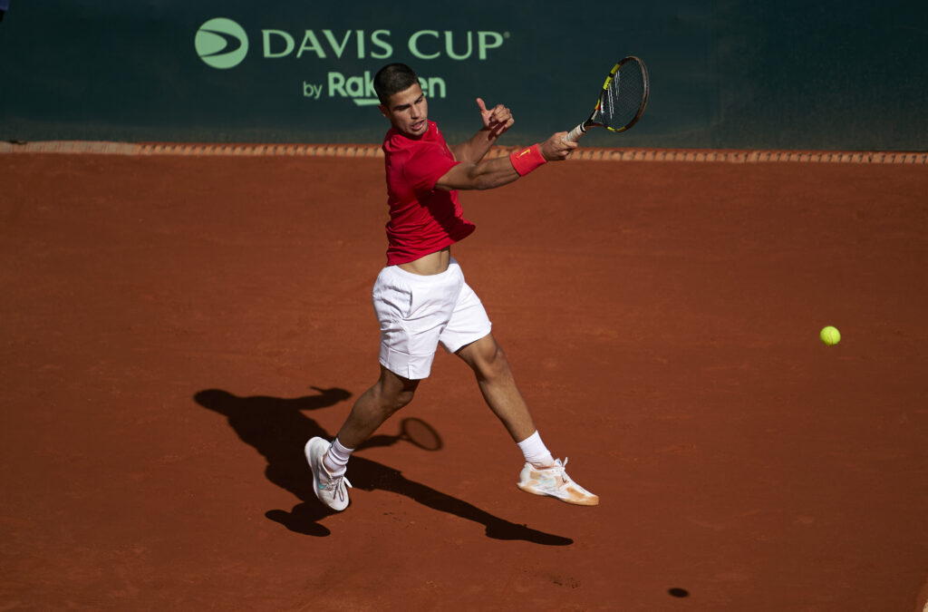 Carlos Alcaraz of Spain returns a ball in his singles match against Marius Copil of Romania during the 2022 Davis Cup Qualifier between Spain and Romania at Club de Tenis Puente Romano on March 04, 2022 in Marbella, Spain.