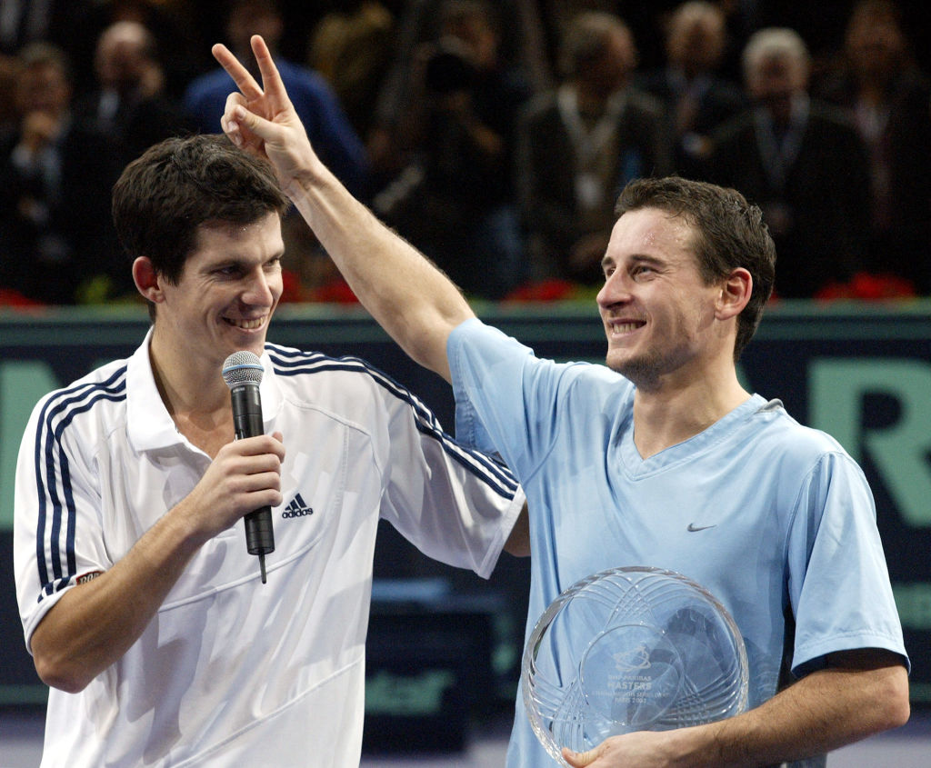 Tim Henman of Great Britain (L) jokes with Andrei Pavel of Romania during the awards ceremony after their Paris ATP Masters Series final match, 02 November 2003 at Bercy indoor tournament in Paris. Henman won 6-2, 7-6, 7-6.