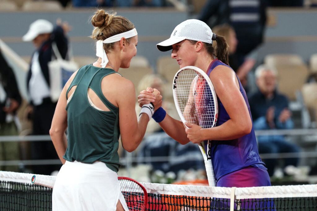 Poland's Iga Swiatek shakes hands with Czech Republic's Marie Bouzkova (L) after winning their women's singles match on Court Philippe-Chatrier on day six of the French Open tennis tournament at the Roland Garros Complex in Paris on May 31, 2024.