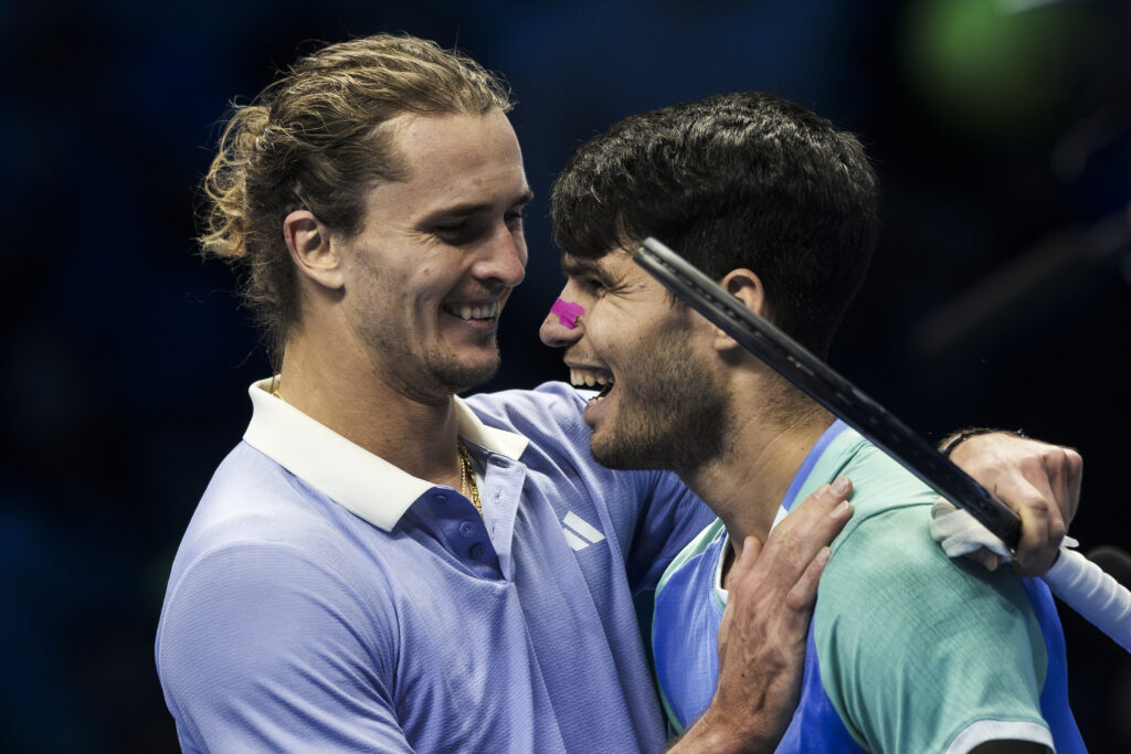 Alexander Zverev (L) of Germany and Carlos Alcaraz of Spain shake hands at the end of their round robin singles match during day six of the Nitto ATP Finals. Alexander Zverev won the match 7-6(5), 6-4.