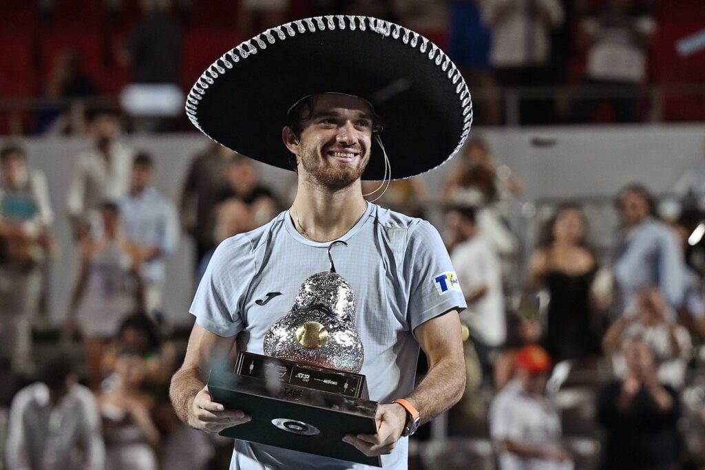 Czech Republic's Tomas Machac holds up the trophy after beating Spain's Alejandro Davidovich Fokina during their 2025 Mexico ATP Open 500 men´s singles tennis final match at the Arena GNP Seguros in Acapulco, Guerrero State, Mexico on March 1, 2025.