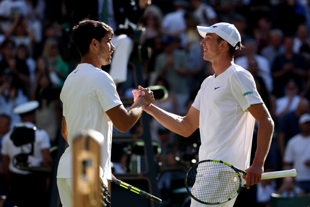 Carlos Alcaraz of Spain greets Oliver Tarvet of Great Britain at the net following his victory during the Gentleman's Singles Second Round match on day three of The Championships Wimbledon 2025 at All England Lawn Tennis and Croquet Club on July 02, 2025 in London, England.