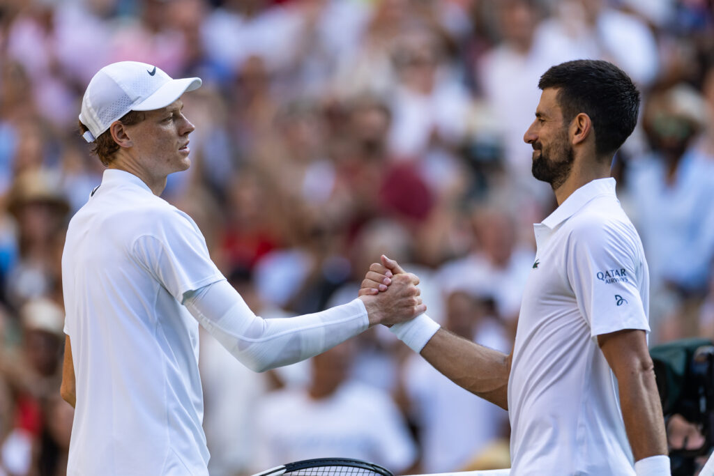 Jannik Sinner of Italy shakes hands with Novak Djokovic of Serbia after beating him i the Gentlemen's Singles semi-finals round match on day eleven of The Championships Wimbledon 2025 at All England Lawn Tennis and Croquet Club on July 11, 2025 in London, England.