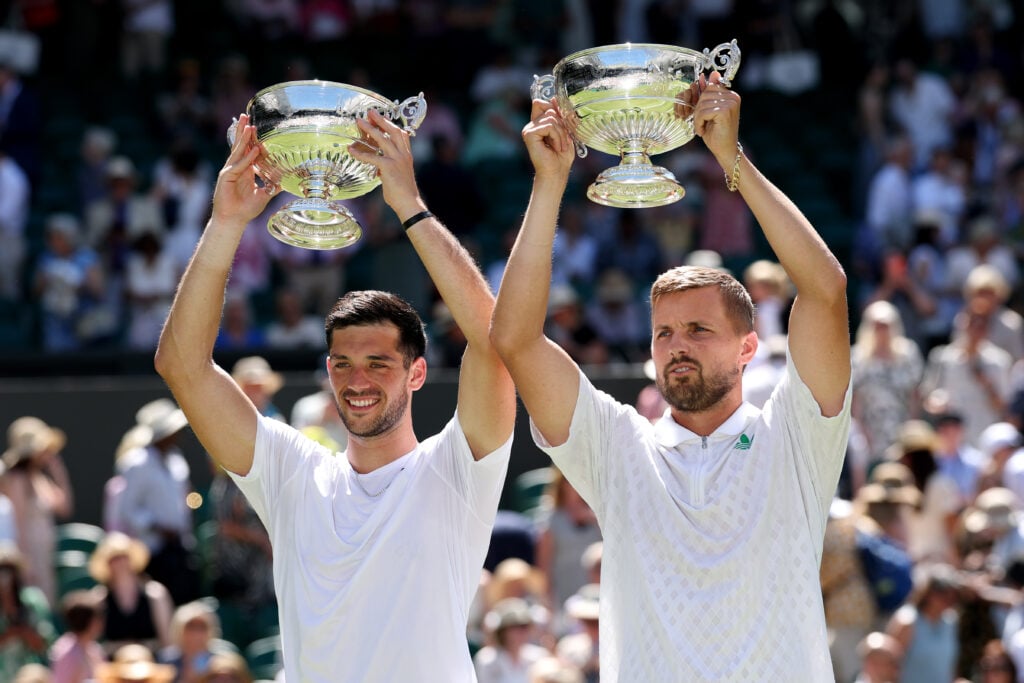 Julian Cash of Great Britain and Lloyd Glasspool of Great Britain lift the Gentlemen's Doubles Trophies following victory against Rinky Hijikata of Australia and David Pel of Netherlands during the Gentlemen's Doubles Final on day thirteen of The Championships Wimbledon 2025 at All England Lawn Tennis and Croquet Club on July 12, 2025 in London, England.