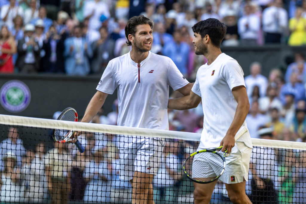 Winner Carlos Alcaraz of Spain and Cameron Norrie of Great Britain embrace at the net after the Quarter-Finals of the Gentlemen's Singles Competition on Centre Court during the Wimbledon Lawn Tennis Championships at the All England Lawn Tennis and Croquet Club at Wimbledon on July 8th, 2025, in London, England.