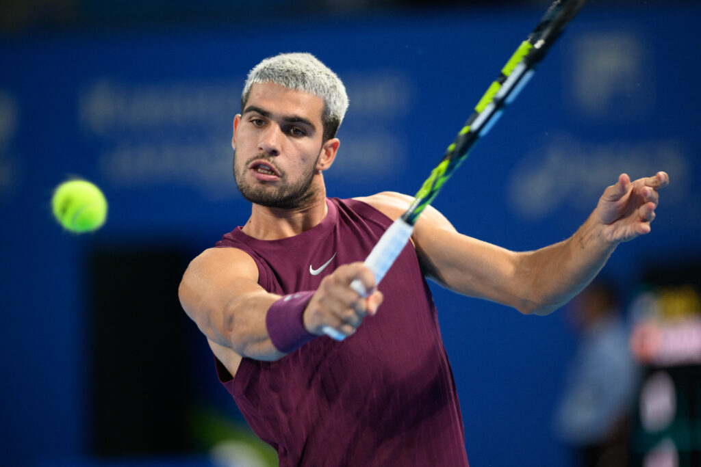 Spain's Carlos Alcaraz hits a return against USA's Brandon Nakashima during their men's singles match at the ATP Japan Open tennis tournament in Tokyo on September 28, 2025.
