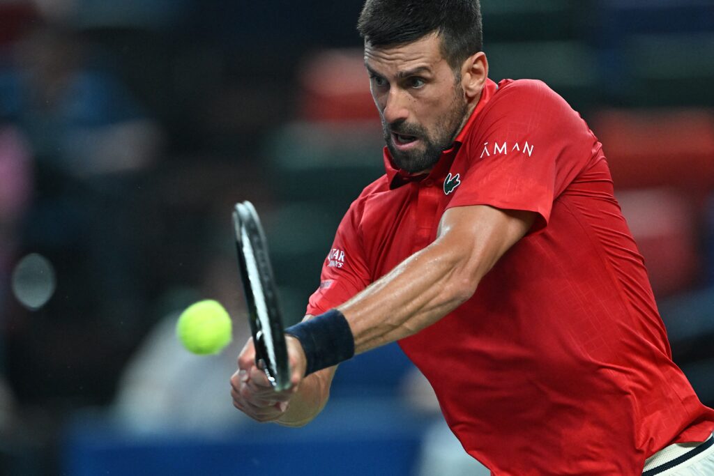 Serbia's Novak Djokovic hits a return to Croatia's Marin Cilic during their men's singles match at the Shanghai Masters tennis tournament in Shanghai on October 3, 2025.