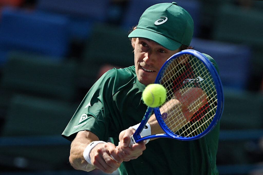 Australia's Alex de Minaur hits a return to Poland's Kamil Majchrzak during their men's singles match at the Shanghai Masters tennis tournament in Shanghai on October 6, 2025.
