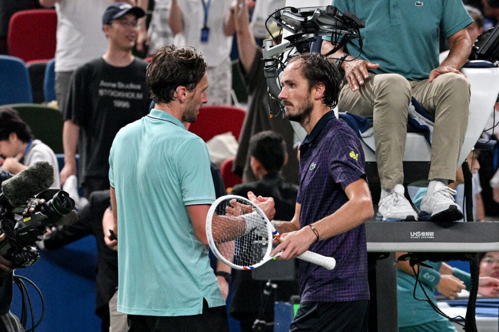 France's Arthur Rinderknech (L) is congratulated by Russia's Daniil Medvedev for his victory at the end of their men's singles semi-final match during the Shanghai Masters tennis tournament in Shanghai on October 11, 2025.