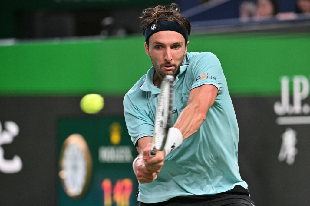 France's Arthur Rinderknech hits a return to Monaco's Valentin Vacherot during the men's singles final at the Shanghai Masters tennis tournament in Shanghai on October 12, 2025.