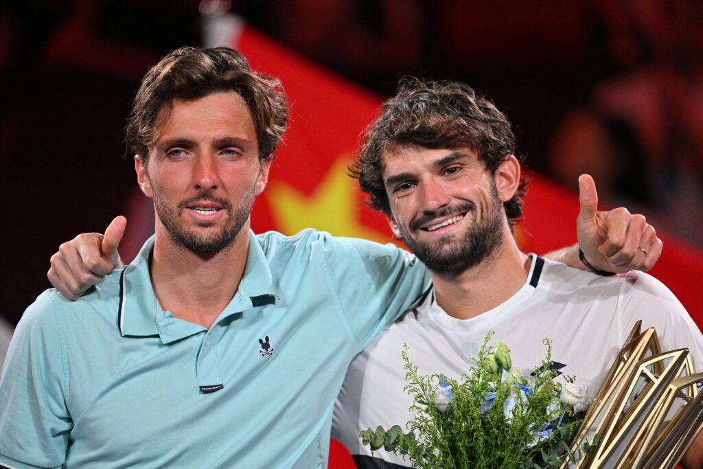 Monaco's Valentin Vacherot (R) poses with the trophy after his victory against France's Arthur Rinderknech (L) during the men's singles final at the Shanghai Masters tennis tournament in Shanghai on October 12, 2025.