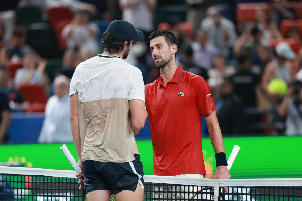 Novak Djokovic of Serbia shaking hands with Valentin Vacherot of Monaco in front net after hislose the Men's singles Semifinals on day 13 of the 2025 Shanghai Rolex Masters at Qi Zhong Tennis Center on October 11, 2025 in Shanghai, China.
