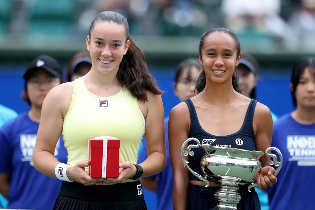 Canada's Leylah Fernandez (R) holds the winner's trophy while posing with runner-up Czech Republic's Tereza Valentova following their women's singles final match at the Japan Open tennis tournament in Osaka on October 19, 2025.