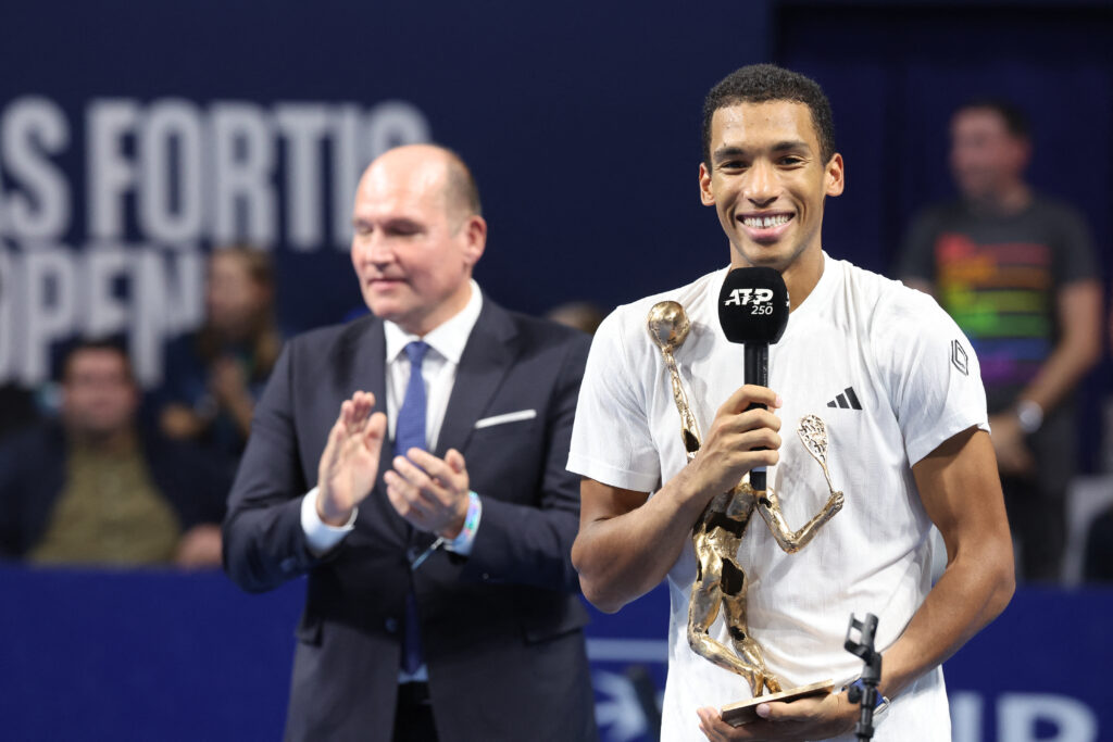 Canada's Felix Auger-Aliassime celebrates with the trophy after winning his men single final tennis match against Czech Republic Jiri Lehecka on day 7 of the European Open ATP tennis tournament in Brussels, on October 19, 2025.