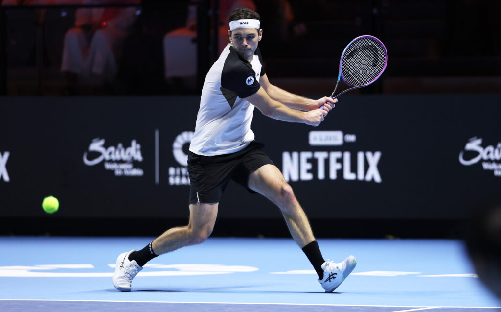 Taylor Fritz of the USA plays a backhand against Novak Djokovic of Serbia (not pictured) during the Men's Single's Third Place match on day three of the Six Kings Slam 2025 at ANB Arena on October 18, 2025 in Riyadh, Saudi Arabia.