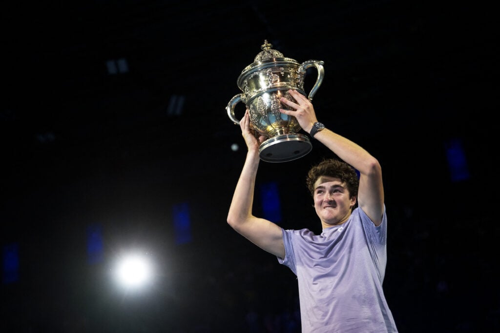 Brazil's Joao Fonseca raises the trophy after winning against Spain's Alejandro Davidovich Fokina in their men's final match at the Swiss Indoors ATP 500 tennis tournament in Basel on October 26, 2025.