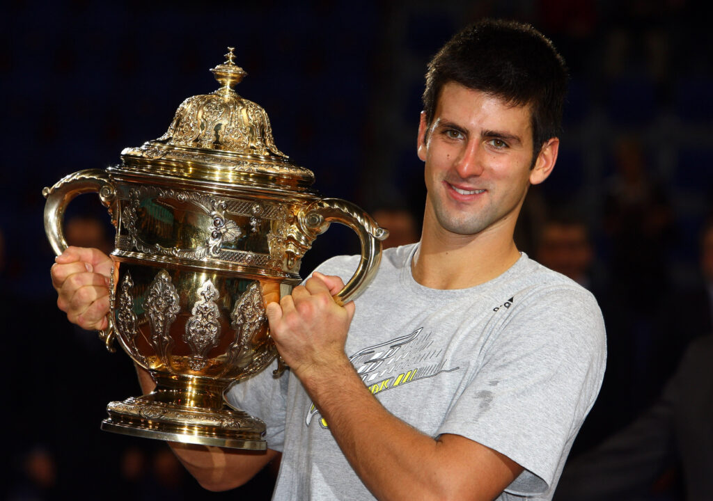 Novak Djokovic of Serbia celebrates with the trophy after defeating Roger Federer of Switzerland in the final during Day Seven of the Davidoff Swiss Indoors Tennis at St Jakobshalle on November 8, 2009 in Basel, Switzerland.