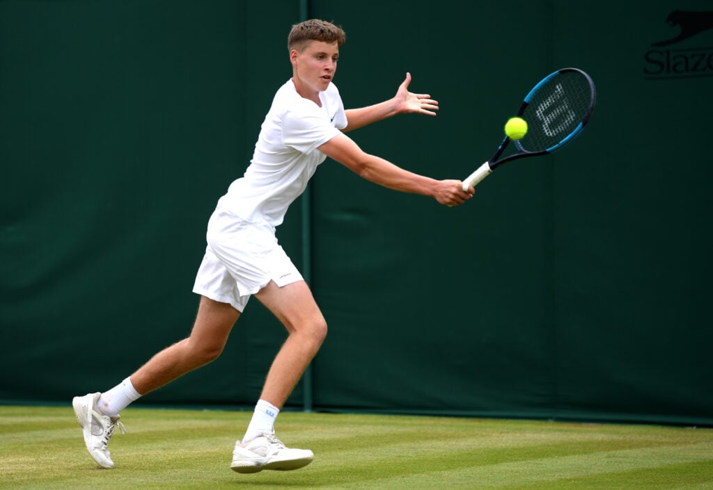 Toby Samuel of Great Britain plays a backhand in his Boys' Singles first round match against Filip Christian Jianu of Romania during Day six of The Championships - Wimbledon 2019 at All England Lawn Tennis and Croquet Club on July 06, 2019 in London, England.