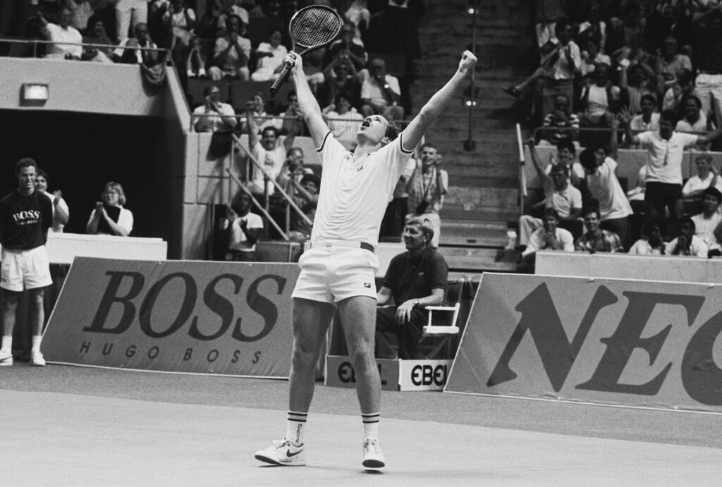 Tennis player John McEnroe celebrates during his 6 hour and 20 minute Davis Cup match against Germany's Boris Becker, in Hartford, CT, April 1987. McEnroe eventually lost to Becker in five sets.