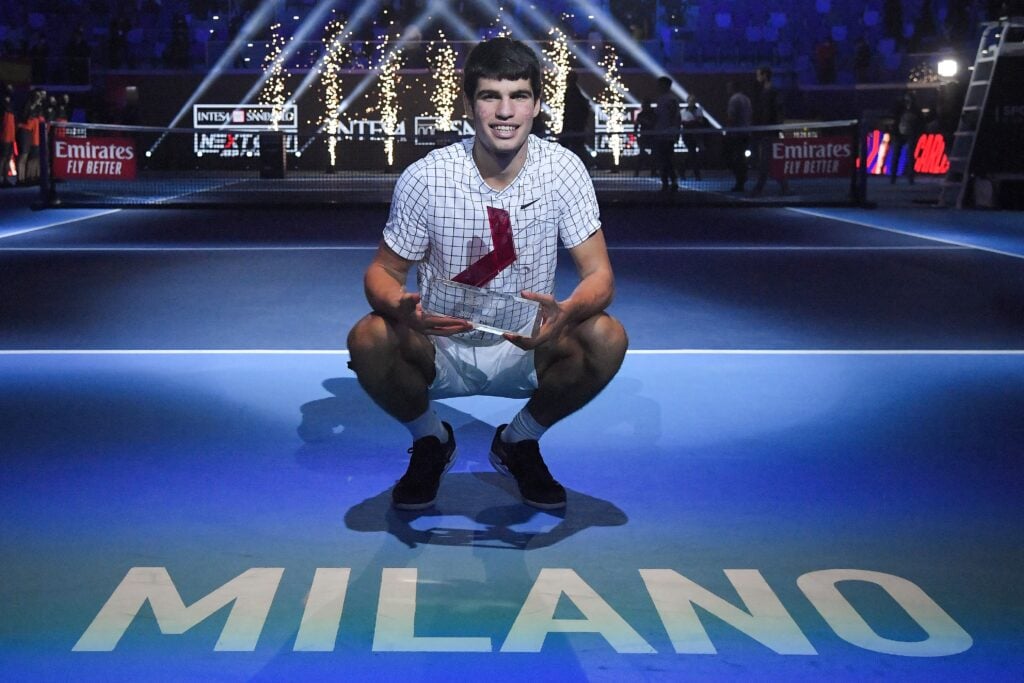 Spain's Carlos Alcaraz poses with his trophy after winning against USA's Sebastian Korda during their final match at the Next Generation ATP Finals tournament at the Allianz Cloud venue in Milan, on November 13, 2021.