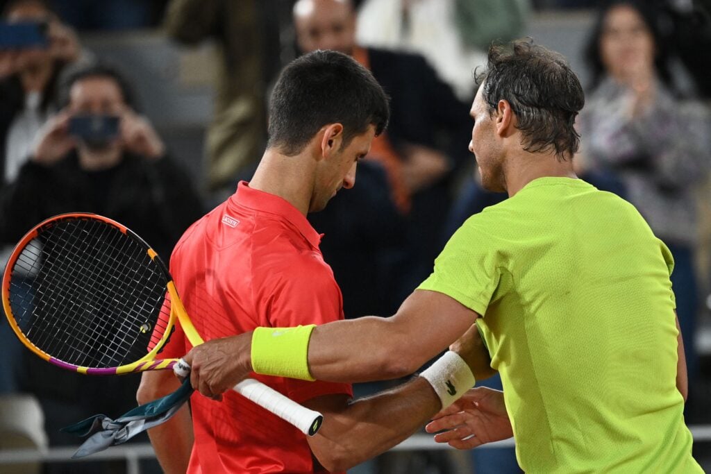 Spain's Rafael Nadal (R) shakes hands with Serbia's Novak Djokovic (L) after winning at the end of their men's singles match on day ten of the Roland-Garros