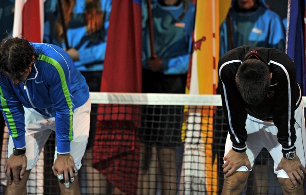 Novak Djokovic of Serbia (R) and Rafael Nadal of Spain (L) look exhausted before the start of the awards ceremony following the men's final match on day 14 of the 2012 Australian Open tennis tournament.