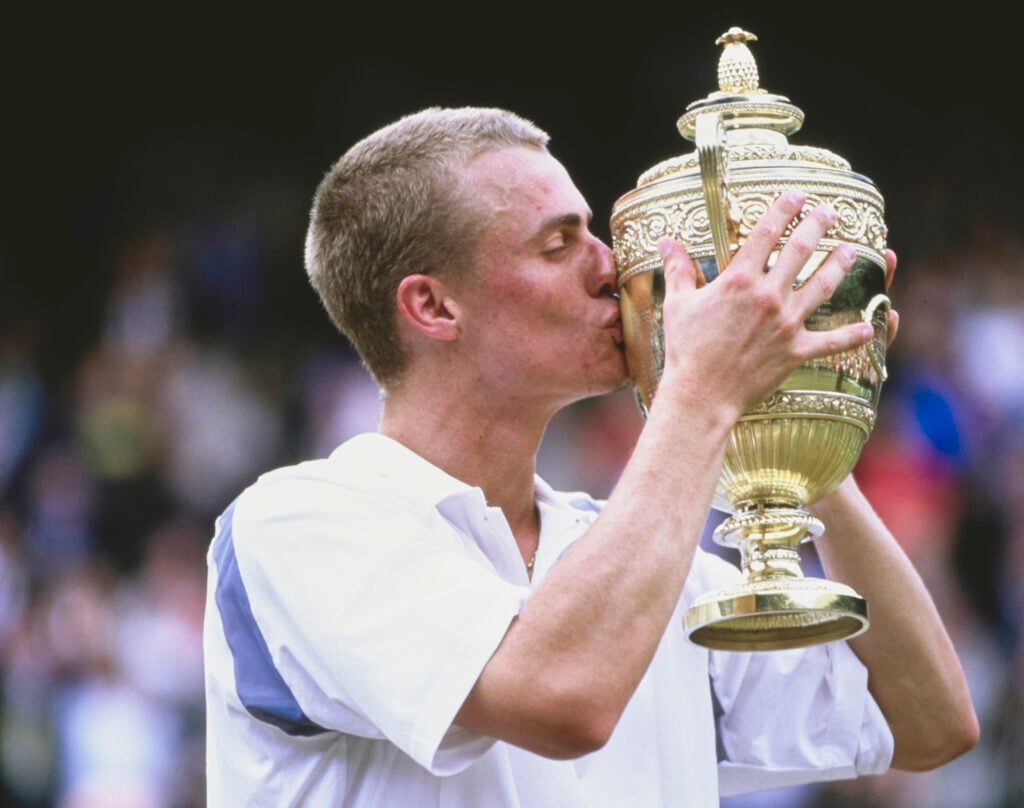 Lleyton Hewitt from Australia kisses the Gentlemen's Singles Championship Trophy after defeating David Nalbandian of Argentina during their Men's Singles Final match at the Wimbledon Lawn Tennis Championship on 7th July 2002.