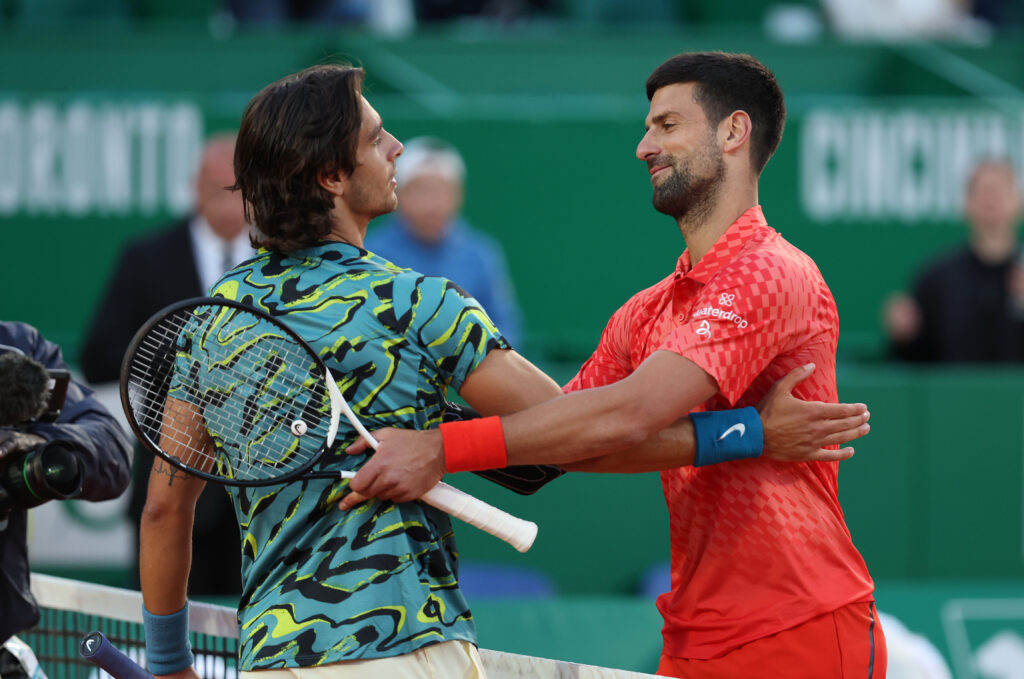 Lorenzo Musetti of Italy shakes hands at the net after his three set victory against Novak Djokovic of Serbia in their third round match during day five of the Rolex Monte-Carlo Masters at Monte-Carlo Country Club