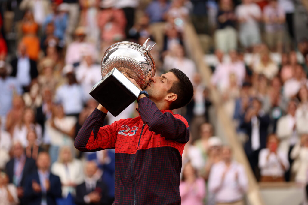 Novak Djokovic of Serbia kisses the winners trophy after victory against Casper Ruud of Norway in the Men's Singles Final match on Day Fifteen of the 2023 French Open at Roland Garros on June 11, 2023 in Paris, France.
